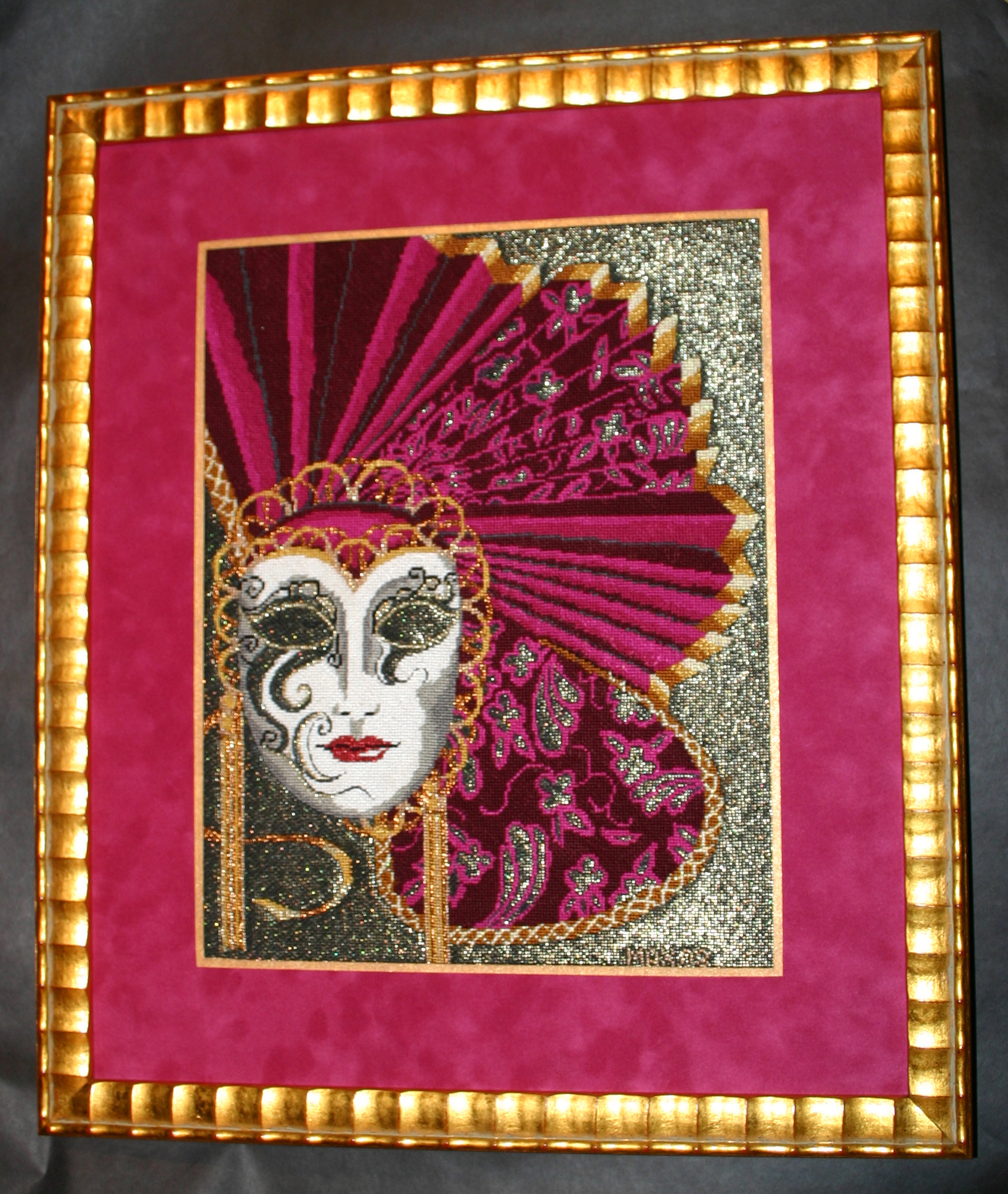 Framed needlepoint of embellished pink mardi gras mask