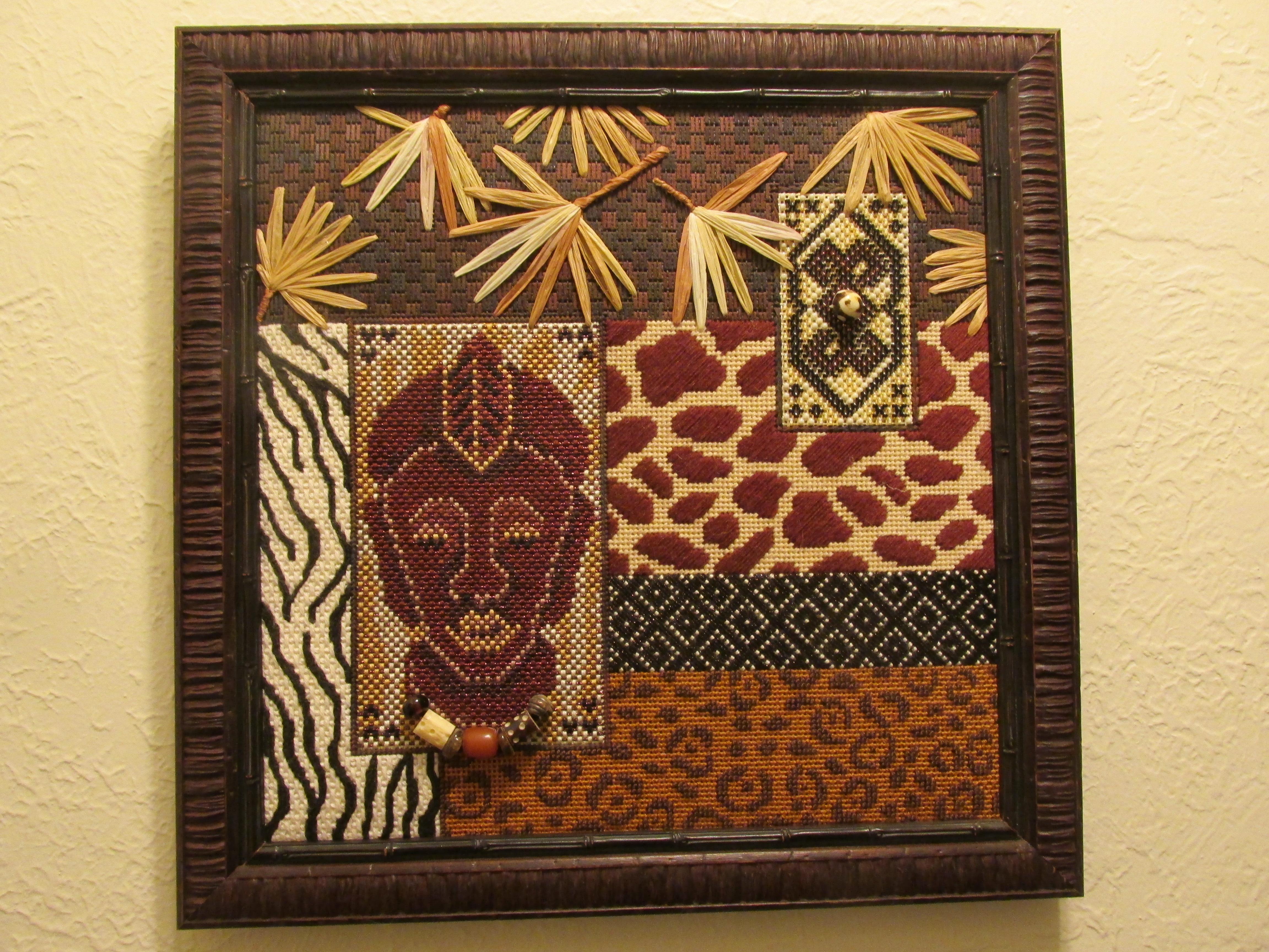  African animal print with mask needlepoint Framed with bark frame